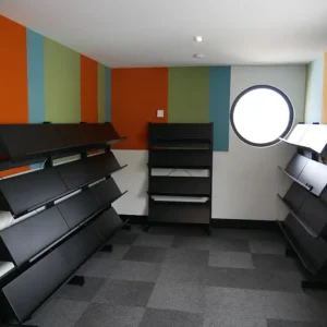 Black display shelves tiered on static shelving