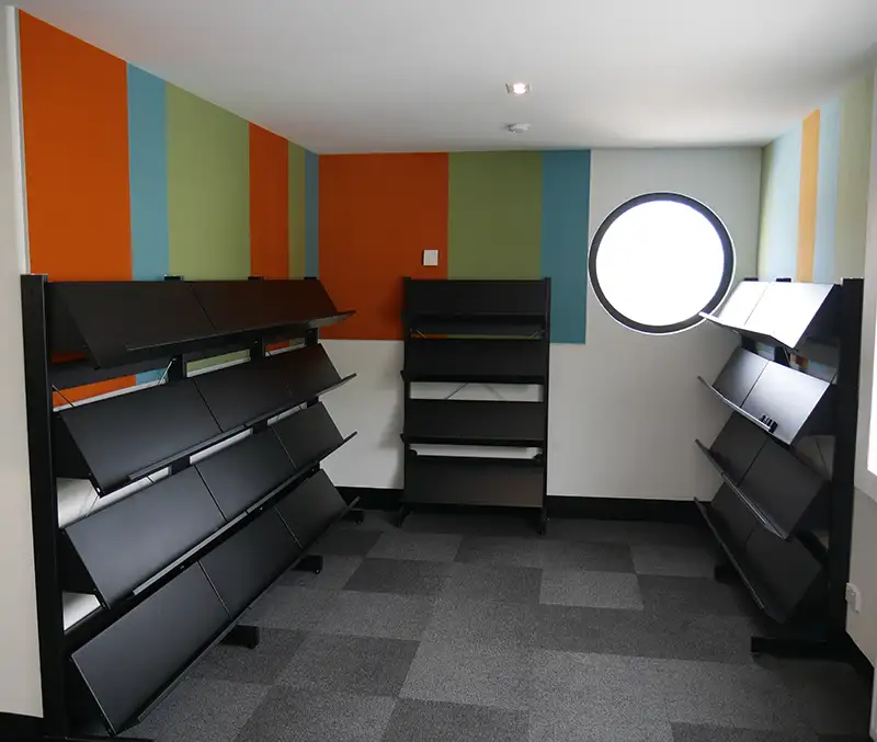 Black display shelves tiered on static shelving